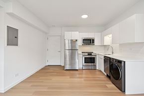 Chicago apartment for rent - A kitchen with white cabinets and stainless steel appliances.