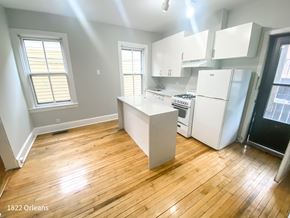 Chicago apartment for rent - A kitchen with wooden floors and white appliances.