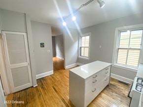 Chicago apartment for rent - A room with a white desk and wooden floors.
