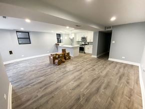 Chicago apartment for rent - A room with wooden flooring and boxes on the floor.
