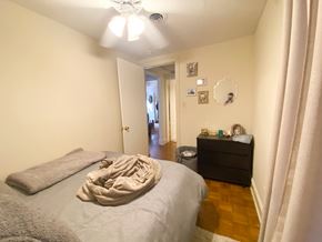 Chicago apartment for rent - A bedroom with a bed, dresser, and mirror.
