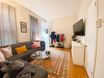 Chicago apartment for rent - A living room with a grey couch and a coffee table.