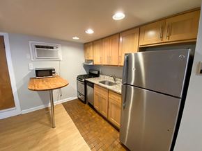 Chicago apartment for rent - A kitchen with a stainless steel refrigerator, microwave, and oven.
