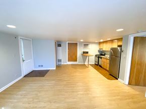 Chicago apartment for rent - A kitchen area with wooden floors and a refrigerator.