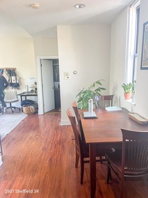 Chicago apartment for rent - A dining room with a wooden table and chairs.