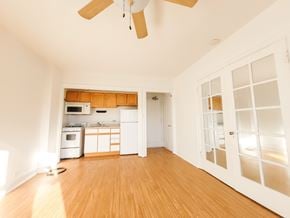 Evanston apartment for rent - A room with a ceiling fan and wooden floors.
