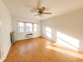 Evanston apartment for rent - A room with a ceiling fan and wooden flooring.