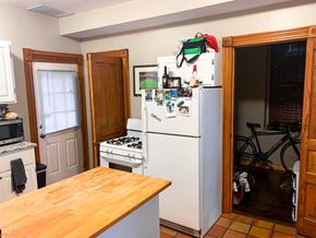 Chicago apartment for rent - A kitchen with a white fridge and a wooden table.