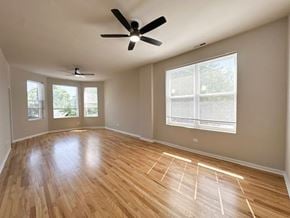 Chicago apartment for rent - A room with wooden flooring and a ceiling fan.