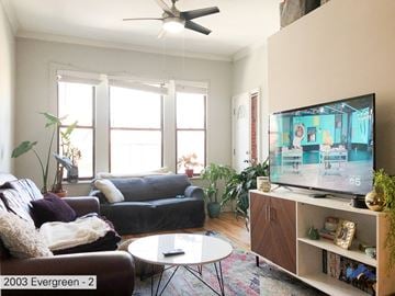 Chicago apartment for rent - A living room with a television on a stand and a couch.