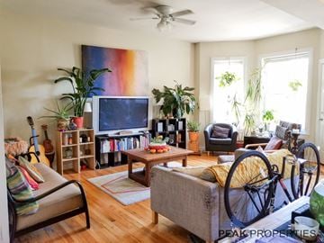 Chicago apartment for rent - a living room with a bike in front of the tv