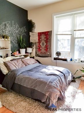 Chicago apartment for rent - a bedroom with a bed and a chalkboard wall and two windows