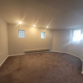Chicago apartment for rent - the living room of an empty house with a carpeted floor