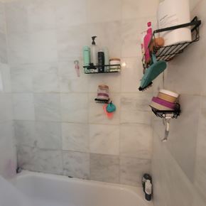 Chicago apartment for rent - A bathroom with a white tub and a shelf with toiletries.