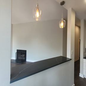 Chicago apartment for rent - a living room with a fireplace and a long counter