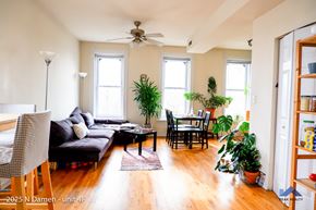 Chicago apartment for rent - A living room with a couch, chairs, and plants.