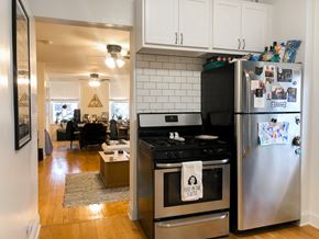 Chicago apartment for rent - A kitchen with a stove and refrigerator with a towel on the stove that says Food in the Unit.