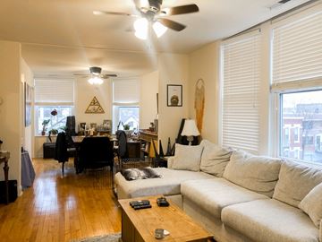 Chicago apartment for rent - A living room with a white couch and a wooden coffee table.