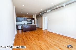 Chicago apartment for rent - the living room of an apartment with wood floors and a kitchen