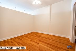 Chicago apartment for rent - the living room of a home with wood floors and white walls