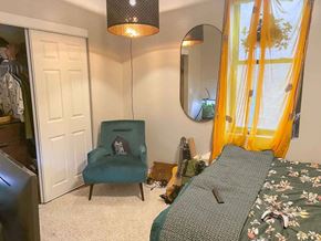 Chicago apartment for rent - A bedroom with a bed, chair, and mirror.