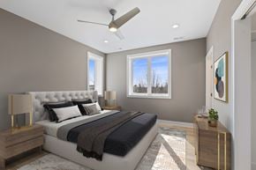 Chicago apartment for rent - A bedroom with a large bed and a ceiling fan.