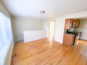 Chicago apartment for rent - an empty kitchen and living room with wood flooring