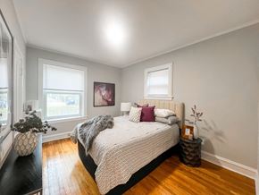 Evanston apartment for rent - A bedroom with a large bed and a wooden floor.