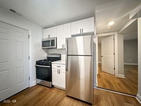 Chicago apartment for rent - A kitchen with a stainless steel refrigerator, oven, and microwave.