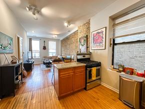 Chicago apartment for rent - A kitchen with a stove top oven and a refrigerator.