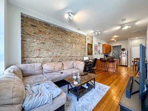 Chicago apartment for rent - A living room with a brick wall and a couch.