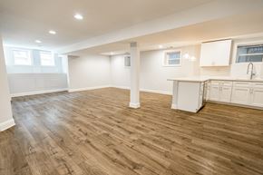 Chicago apartment for rent - A spacious room with wooden flooring and white cabinetry.