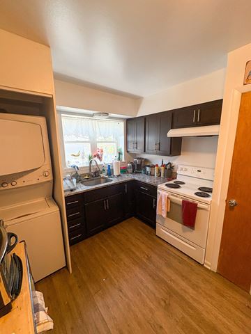 Evanston apartment for rent - A kitchen with a white oven and black cabinets.