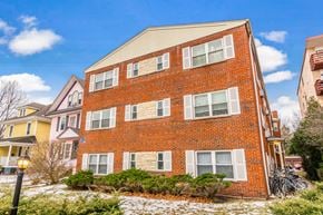 Evanston apartment for rent - A red brick building with a white window on the second floor.