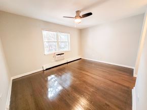 Evanston apartment for rent - A room with a ceiling fan and a window.