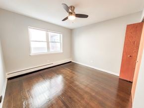 Evanston apartment for rent - A room with a ceiling fan and a window.