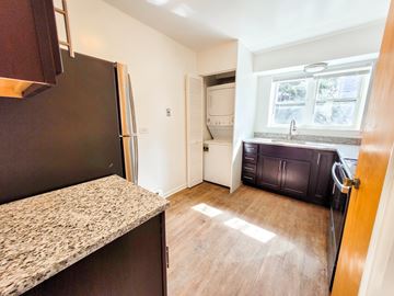 Evanston apartment for rent - A kitchen with a granite countertop and a refrigerator.