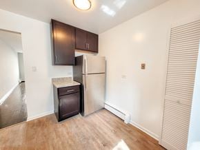 Evanston apartment for rent - A kitchen with a refrigerator, microwave, and cabinets.