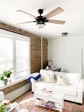 Chicago apartment for rent - a living room with a white couch and a ceiling fan