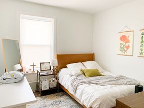 Chicago apartment for rent - a bedroom with a bed and a desk and a window
