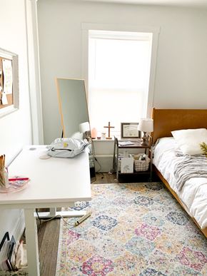 Chicago apartment for rent - a small bedroom with a bed and a desk and a mirror