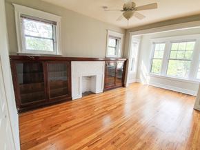 Chicago apartment for rent - A room with wooden floors and a fireplace.