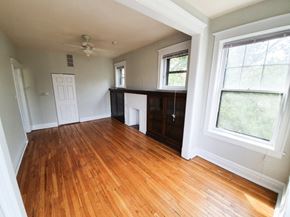 Chicago apartment for rent - A room with wooden floors and white walls.