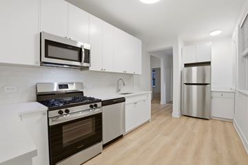 Evanston apartment for rent - A kitchen with white cabinets and stainless steel appliances.