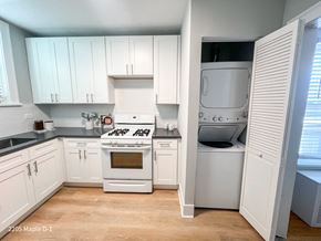 Evanston apartment for rent - A kitchen with a white stove and white cabinets.