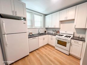 Evanston apartment for rent - A kitchen with white appliances and wooden floors.