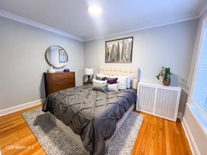 Evanston apartment for rent - A bedroom with a bed, nightstand, and a painting on the wall.
