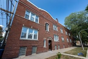Chicago apartment for rent - a red brick building with a sidewalk in front of it