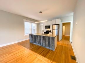 Chicago apartment for rent - A kitchen with a wooden floor and a grey counter.