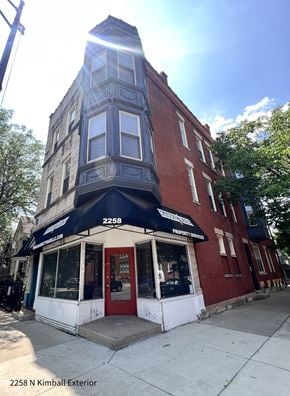 Chicago apartment for rent - a building on the corner of a street with a red door and a black awning